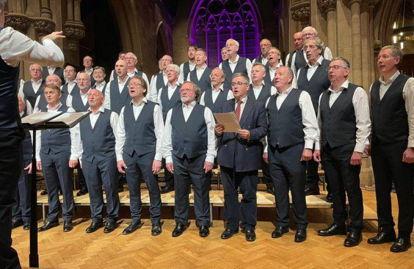 Robert Buckland MP pictured with the Wessex Choir Performing at The High Sheriff of Wiltshire’s Annual Charity Concert in aid of Rotary Swindon Cares